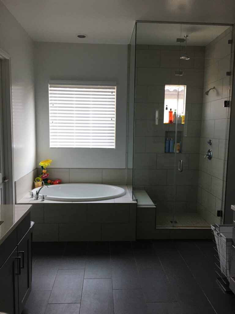 Spotless and shining bathroom with a meticulously cleaned bathtub, epitomizing deep cleaning services, with sparkling tiles and a clutter-free ambiance, highlighting attention to detail in hygiene and cleanliness.