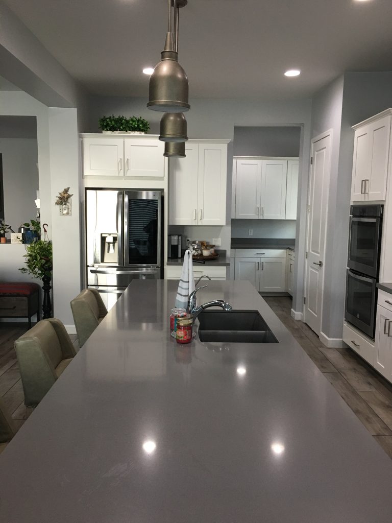 Immaculately clean and well-organized kitchen with gleaming surfaces, showcasing an uncluttered countertop and spotless appliances, reflecting the high standards of optimum cleaning services